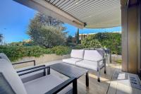 a patio with two white chairs and a table at IMMOGROOM - Close beaches - Terrace with sea view - pool -AC in Cannes