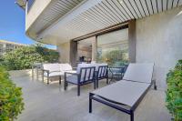 a group of chairs and tables on a patio at IMMOGROOM - Close beaches - Terrace with sea view - pool -AC in Cannes