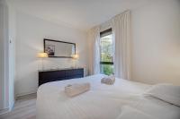 a bedroom with a large white bed with two towels on it at IMMOGROOM - Close beaches - Terrace with sea view - pool -AC in Cannes