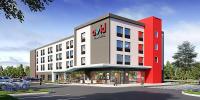 un rendimiento de un edificio con un coche aparcado fuera en avid hotel - Hays by IHG, en Hays