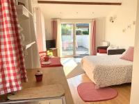 a bedroom with a bed and a living room at Cottage Blagnac in Beauzelle