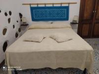 A bed or beds in a room at Casa Vacanza Sa Prenda