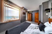 A bed or beds in a room at Petrov Family Hotel
