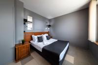 A bed or beds in a room at Petrov Family Hotel