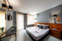 A bed or beds in a room at Petrov Family Hotel