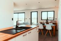 a kitchen with a sink and a table with chairs at Le Paradis du petit Rupembert in Wimille