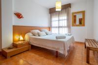 A bed or beds in a room at HomeHolidaysRentals Adara