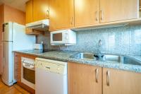A kitchen or kitchenette at HomeHolidaysRentals Adara