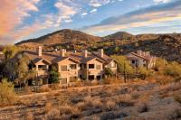 a row of houses in a field with mountains in the background at Raintree at Phoenix South Mountain Preserve in Phoenix