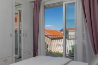 Postel nebo postele na pokoji v ubytování Hortenzija Apartments