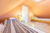 A bed or beds in a room at Cédrus Nyaralóház, Gyopárosfürdő