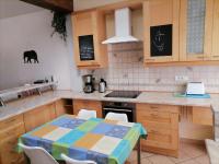 a kitchen with a table and a stove top oven at Gite Louvre Opale in Desvres