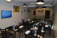 a dining room with tables and chairs with flowers on them at Royal Inn Residence in Cairo