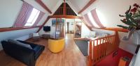 an overhead view of a living room with a couch at Gîte &quot;Entre fraises et mer&quot; in Landrethun-lès-Ardres