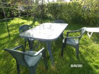 two chairs and a table and a table and chairs at Calme de la campagne in Le Torp-Mesnil