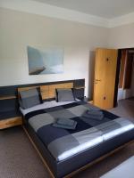 Una cama grande con dos almohadas encima en una habitación. en Penzion Lokotka Děčín, en Děčín
