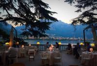 a group of people sitting at tables in a restaurant at Boutique Hotel Villa Giulia in Valmadrera