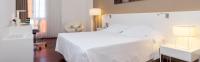 A bed or beds in a room at URH Ciutat de Mataró