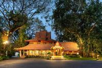 a large house with lights on the front of it at Yaang Come Village Hotel in Chiang Mai