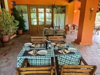 a table with plates and napkins on it in a restaurant at Hotel Il Casolare in Noghera