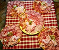 a table with many different pizzas on it at Hotel Il Casolare in Noghera