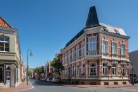 a building on a street in a city at Alt-Emder Bürgerhaus in Emden