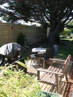 a patio with a table and chairs and a tree at La Houle, maison classée 4 étoiles in Criel-sur-Mer