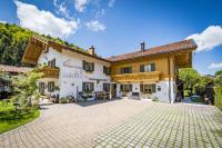 an exterior view of a house with a patio at Pension Gimpl, Chiemgaukarte neu in Siegsdorf