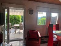 a living room with a door open to a patio at LA PETITE MESANGE in Dabo