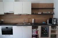 a kitchen with white cabinets and a sink at Hotel Garni Löwen in Silz