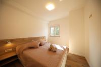 Postel nebo postele na pokoji v ubytování Apartmani Kiara