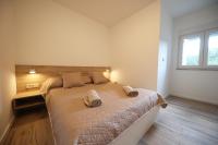 Postel nebo postele na pokoji v ubytování Apartmani Kiara