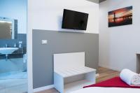 Televízia a/alebo spoločenská miestnosť v ubytovaní Venice Rooms
