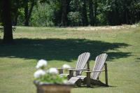 two chairs sitting in the grass in a park at Manoir de Malagorse in Cuzance