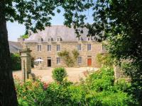 an old stone house with a garden in front of it at Manoir le Cosquer in Pommerit-le-Vicomte