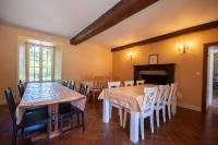 a dining room with a table and chairs and a fireplace at Manoir le Cosquer in Pommerit-le-Vicomte