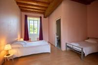 a bedroom with a large bed and a window at Manoir le Cosquer in Pommerit-le-Vicomte