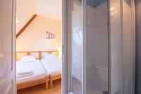 a bedroom with a bed and a glass shower at Manoir le Cosquer in Pommerit-le-Vicomte