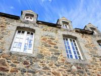 a building with three windows on top of it at Manoir le Cosquer in Pommerit-le-Vicomte
