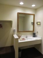 a bathroom with a sink and a mirror at Anaheim Desert Inn & Suites in Anaheim