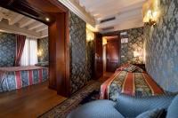 a room with two beds and a couch in it at Royal San Marco Hotel in Venice