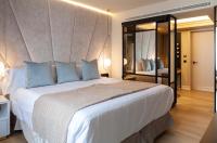 A bed or beds in a room at Nivia Born Boutique Hotel