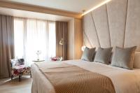 A bed or beds in a room at Nivia Born Boutique Hotel