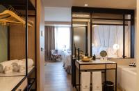 A bed or beds in a room at Nivia Born Boutique Hotel