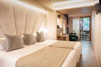 A bed or beds in a room at Nivia Born Boutique Hotel