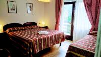 Łóżko lub łóżka w pokoju w obiekcie HG Hotel Italia
