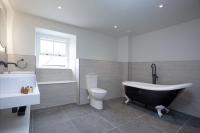 a bathroom with a tub and a toilet and a sink at Pilgrim, Maritime Suites, Brixham in Brixham