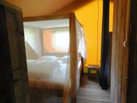 a bedroom with two beds and a window at Rives Nature in La Gacilly