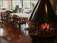 a fireplace in a room with a table and chairs at Guesthouse Sakuya in Fujikawaguchiko