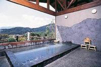 a swimming pool in a building with a view of the mountains at Guesthouse Sakuya in Fujikawaguchiko